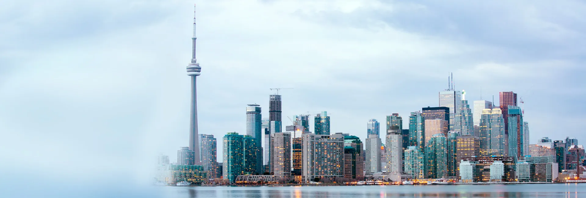 Toronto skyline with the CN Tower on a soft pale-blue day